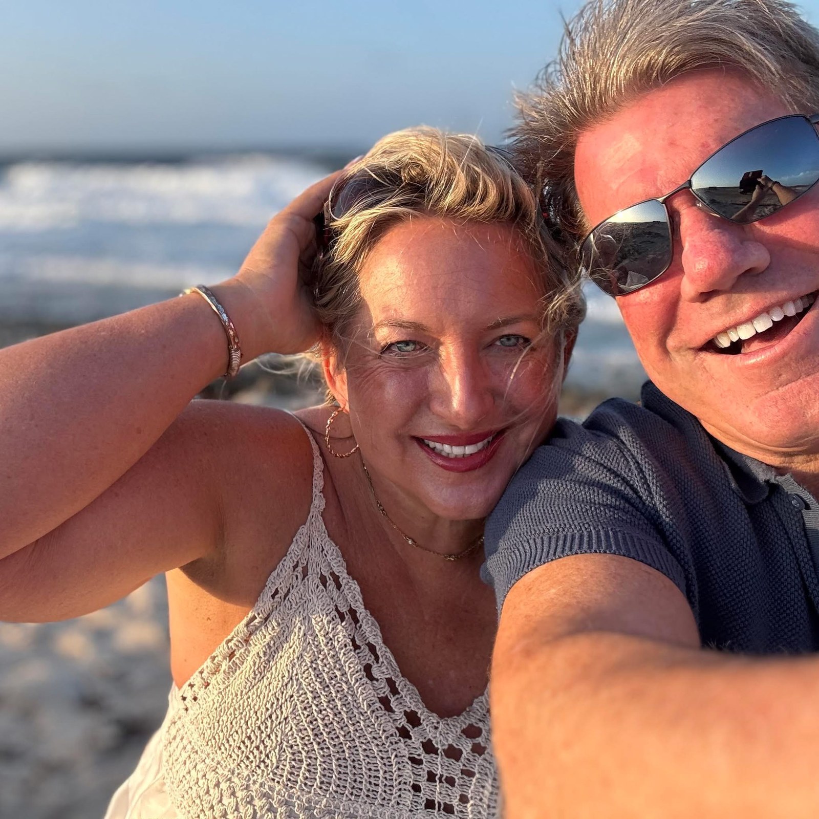 Liz laughing on the beach with the one she loves